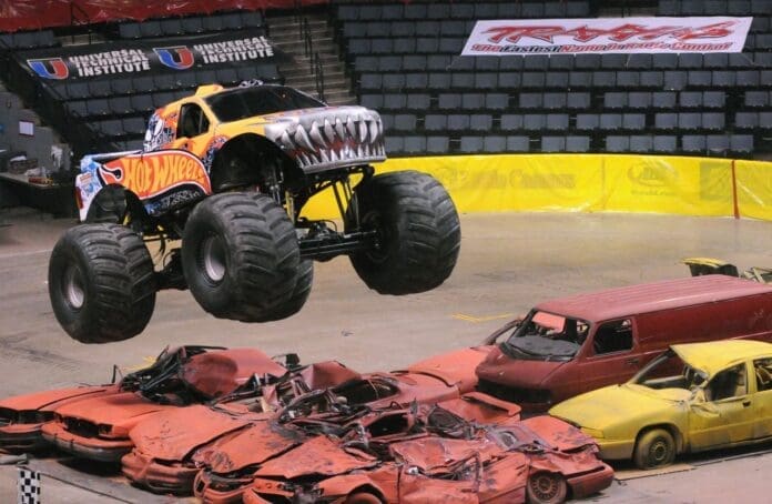 A monster truck in the air. Keywords: monster truck, air.