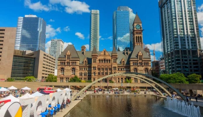 Toronto's city hall is in the background with a fountain in the foreground, showcasing diversity.