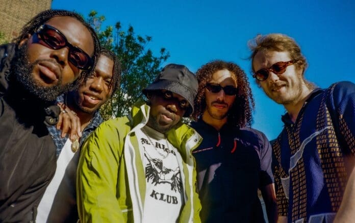 A group of men posing for a picture at the Mercury Prize win celebration.