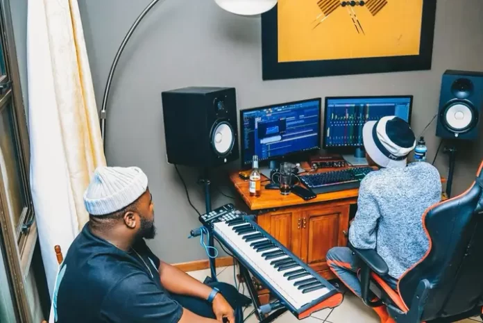 Two men, MDU and TRP, sitting in a recording studio.