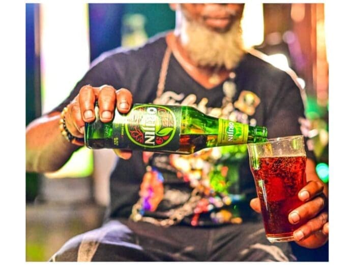 A man celebrating with a glass of Orijin's Blend beer.