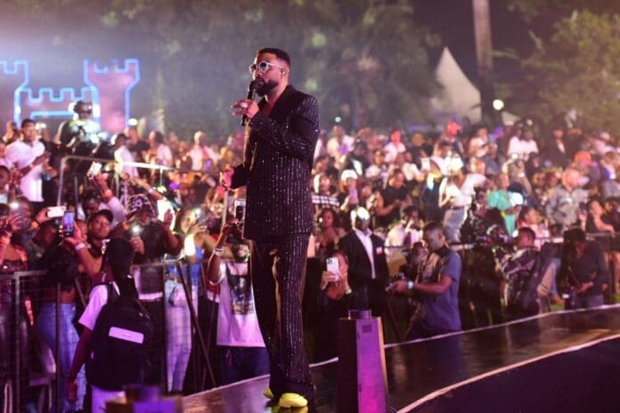 A man in a suit standing on stage.