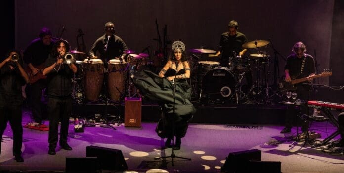 A group of people on stage with top Brazilian musical instruments performing at UC Theatre.