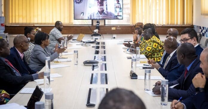 A diverse group of people sitting around a conference table, embracing their cultural differences in peaceful harmony.